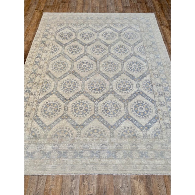 A lovely vintage Khotan rug. This vintage Khotan offers a neutral color palette with light blue accents.