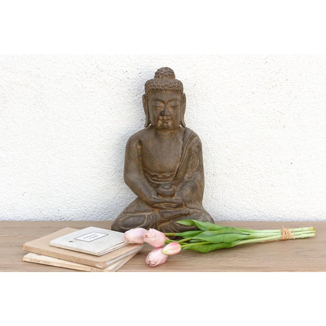 Introduce a profound sense of peace and spiritual artistry to your space with this magnificent hand-carved stone Buddha....