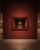 Large rectangular wall mirror featuring a reddish-brown wood frame with a classic stepped trim design. The piece has a...