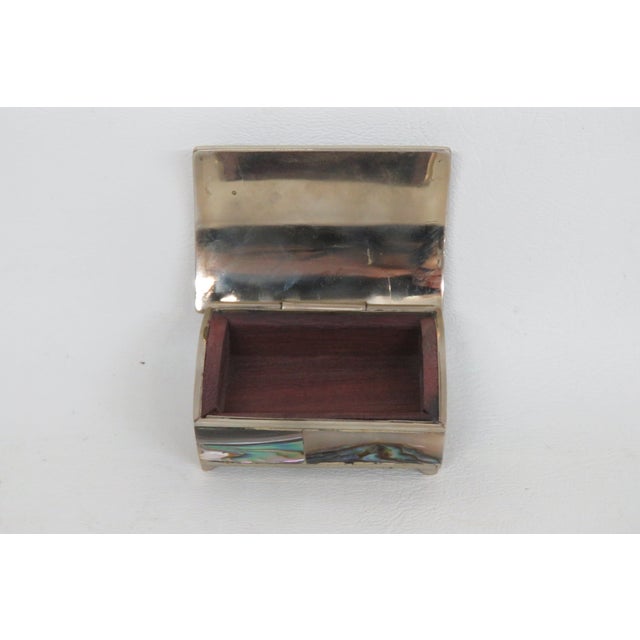 This lovely Trinket Box is made of metal and wood. This gorgeous Abalone Vintage Jewelry Box with inlaid pieces of...