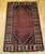 A vibrant mid-20th century vintage Turkish village area rug of outstanding energy and color — its brilliant red field...