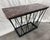 A striking console table featuring a honed Breccia marble top and a hand‑formed steel base by metalworker Jon Little. The...