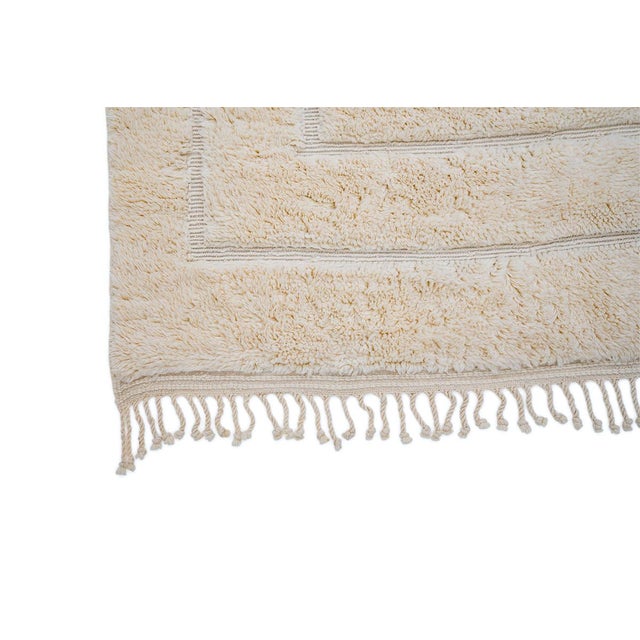 Elegant hand-knotted wool rug in a soft Ivory palette. Featuring intricate geometric patterns, this versatile piece adds...