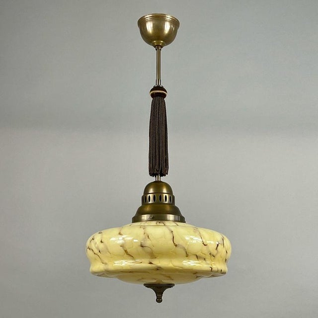This art deco pendant was manufactured and designed in germany in the 1930s. The light features an elegant marbled glass...