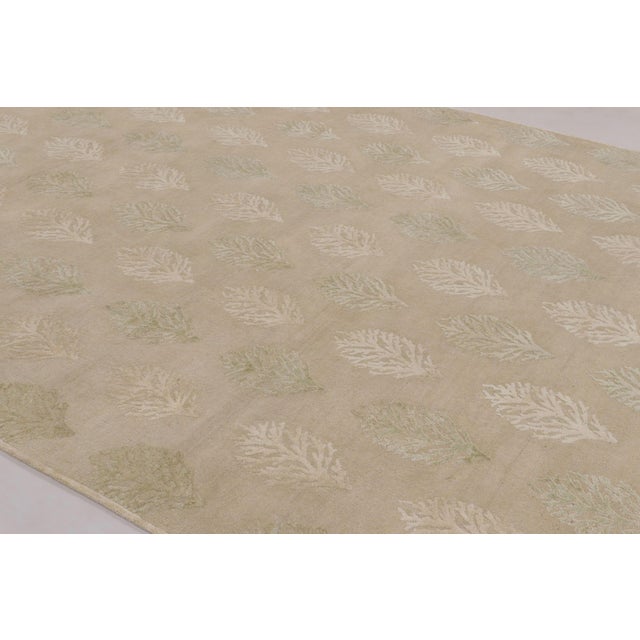 Hand-knotted in a luxurious blend of wool and silk, this 9x12 rug is a serene and sophisticated addition to the Block...