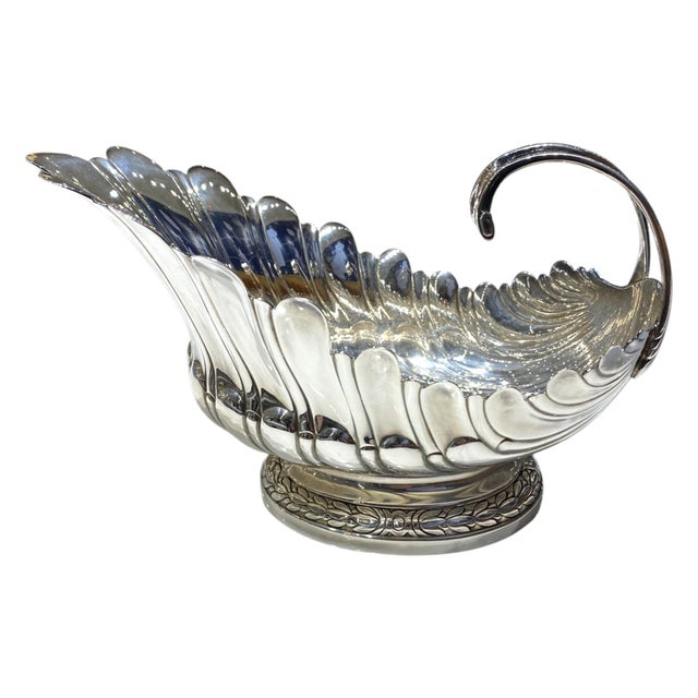 This is a stunning silver-plate sauce or gravy boat produced in 1986 by the Metropolitan Museum of Art (MMA), faithfully...