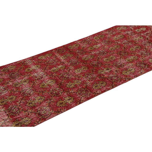 This vintage runner rug is a 3x10 Turkish distressed piece, made with hand-knotted wool circa mid-20th century. It is an...