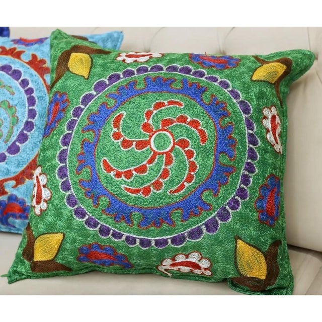 Infuse your home with the rich heritage of Central Asia with this exquisite Hand-Embroidered Suzani Cushion Cover, crafted...