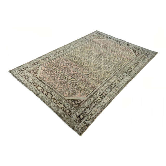 This distinctive, hand-knotted rug with a vintage look combines traditional ornamentation with a subtle, modern color...
