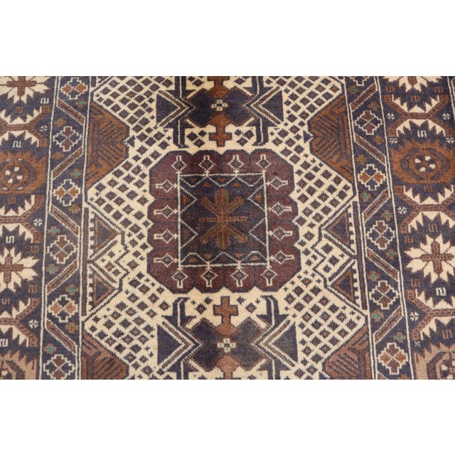 This stunning vintage Afghan Baluch rug was hand-knotted in the 1980s in Herat, Afghanistan, showcasing the rich artistry...