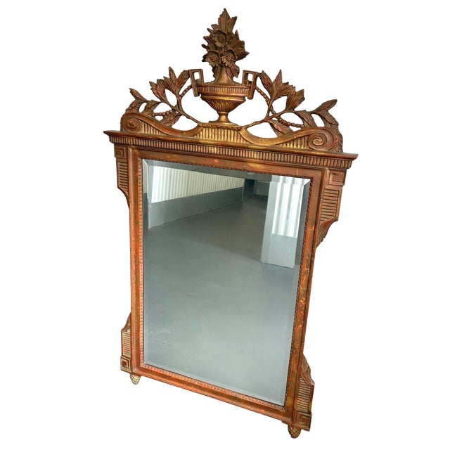 Louis XVI French style floral urn mirror. Antique gold leaf with red and very light hues of green patina. A beautiful...