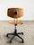 Minimalist vintage swivel chair with a beautifully aged molded plywood seat shell and a striking black star base on...