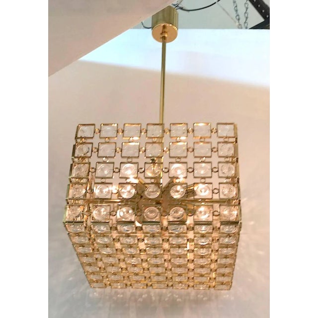 A truly unique and beautiful Italian 1970s gold on brass chandelier in a cube shape with crystal disk accents and...