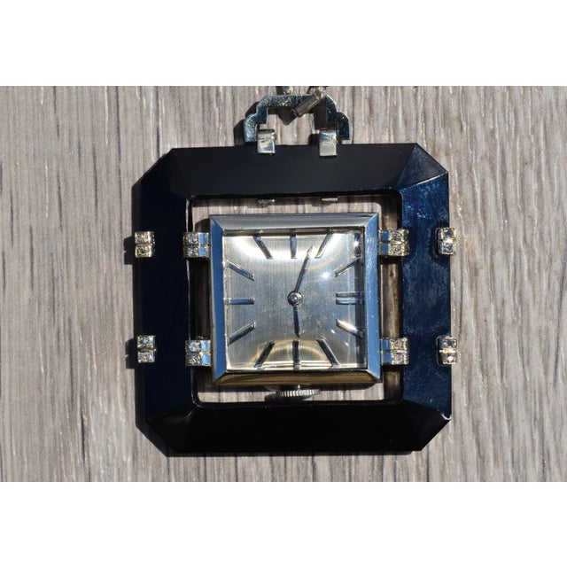The Alanson Ladies Swiss Aster Signed Watch with Onyx and Diamond Frame. Extremely well made, this watch pendant features...