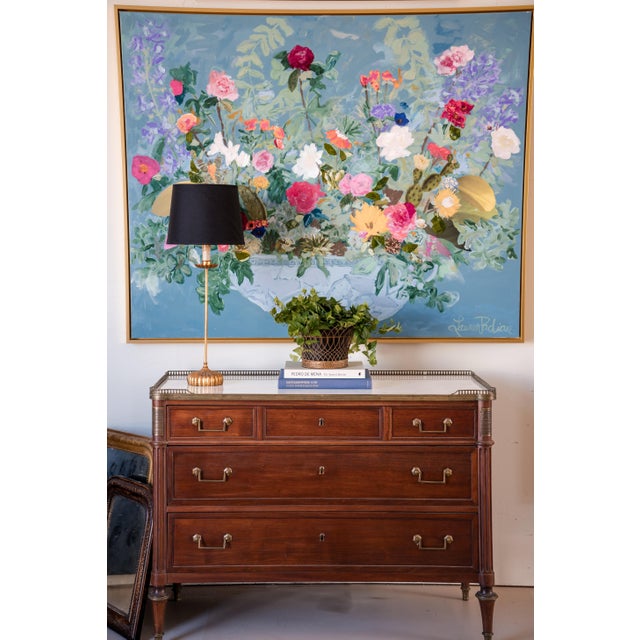 An exquisite French commode from the late 18th to early 19th century, crafted in walnut with brass detailing and topped...