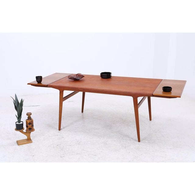A rare teak dining table by Niels Otto Møller for J.L. Møllers Møbelfabrik. The clean lines, tapered legs, and beautifully...