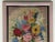 Beautiful floral professionally framed needlepoint with stitched signature made in 1987. Color of outer edge of frame...