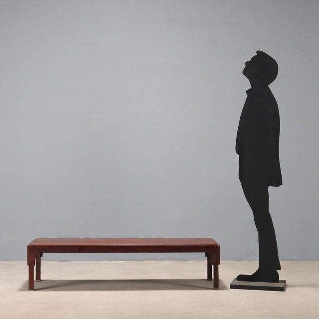 Vintage coffee table with exotic wood veneer and metal legs. This piece is attributed to the mentioned designer/maker. It...