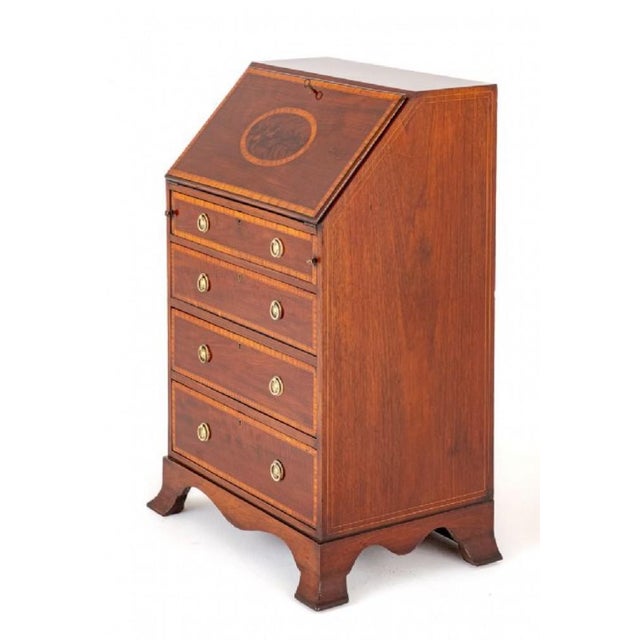 Sheraton Revival mahogany ladies bureau. This bureau stands upon splay feet with a shaped frieze. Circa 1890 having 4...