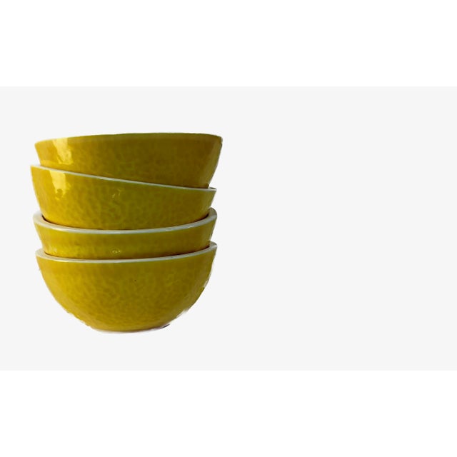 A delightful and vibrant set of four vintage ceramic bowls, representing the playful, nature-inspired aesthetic of Mid-...