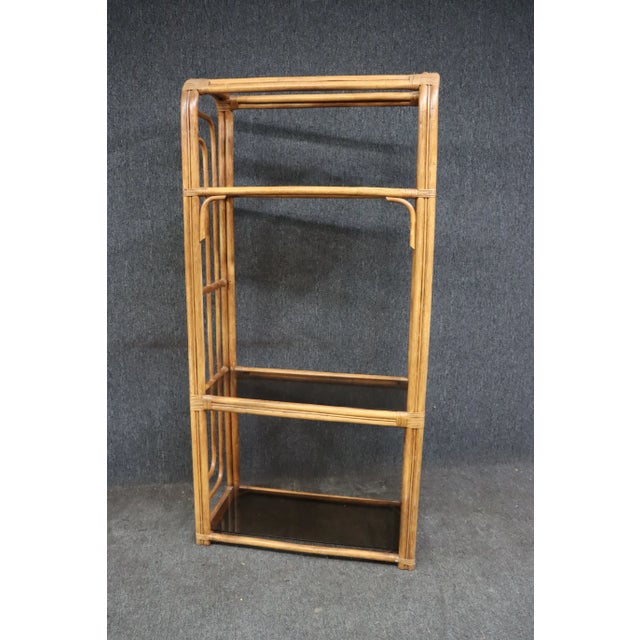 Mid Century faux bamboo rattan etagere with tinted glass shelving.
