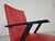 Pair of mid century armchairs in red skai (leatherette) upholstery and black lacquered wooden armrests and legs. Nice...