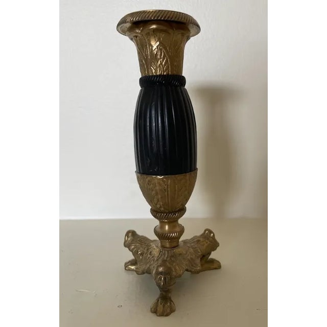 Vintage solid brass and black candlestick has very ornate footed base. This item is very heavy and sturdy weighing in at...