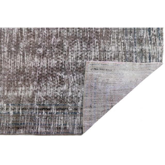 Elevate your space with this exceptional 19th-century Antique Tabriz wool rug, featuring an exquisitely distressed, low-...