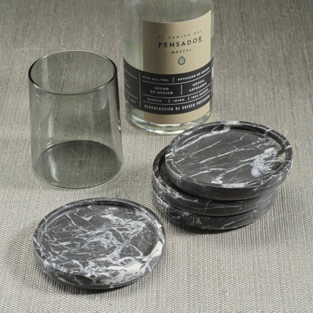 Sophisticated and timeless — this set of four coasters is carved from black marble with striking white veining running...