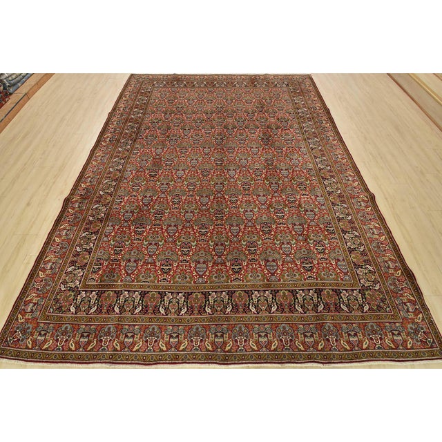 An authentic vintage traditional Tabriz rug hand-knotted with fine wool and natural dyes. This intricately woven rug...