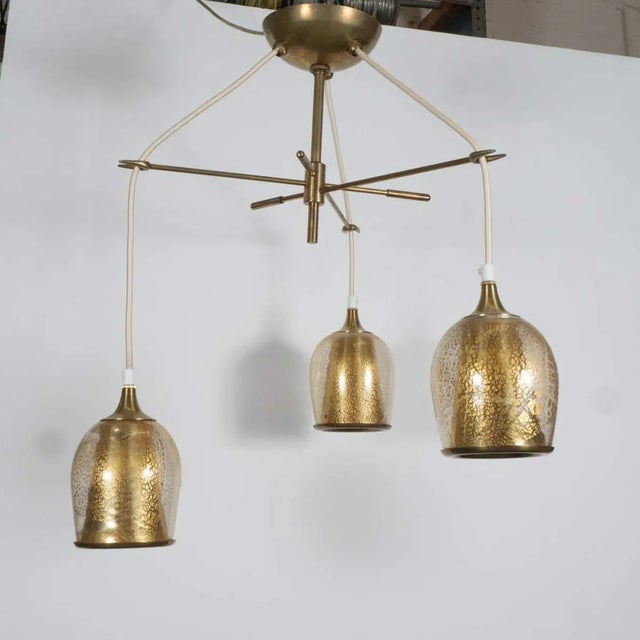 Brass chandelier frame with adjustable cords ending in gold-flecked Murano glass shades. Measured as shown.