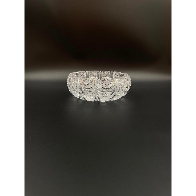A decorative bowl from the communist era, crafted from high-quality crystal glass. The bowl features a rich, hand-cut...