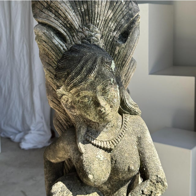 Traditional Indonesian mermaid sculpture in volcanic limestone. Total height: 82 cm; Base dimensions: 24 x 25 cm; Maximum...
