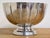 Vintage silver toned aluminum footed bowl featuring an elegant scalloped rim and round footed base. Unmarked by a maker....