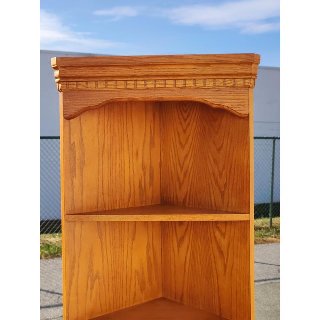 A pair of late 20th century Traditional solid oak corner shelving units or etageres, each having four shelves Circa 1989....