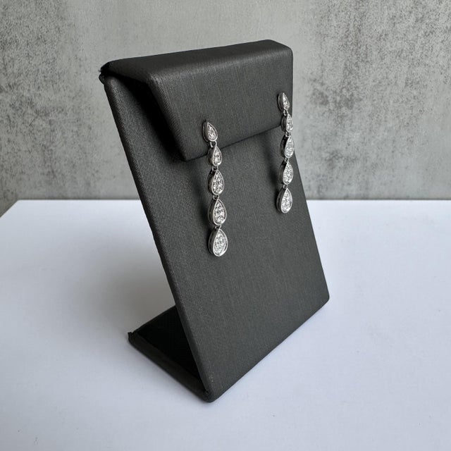 Unveil the epitome of elegance with our Natural Diamond Drop Earrings. Crafted in lustrous 10kt white gold and adorned...