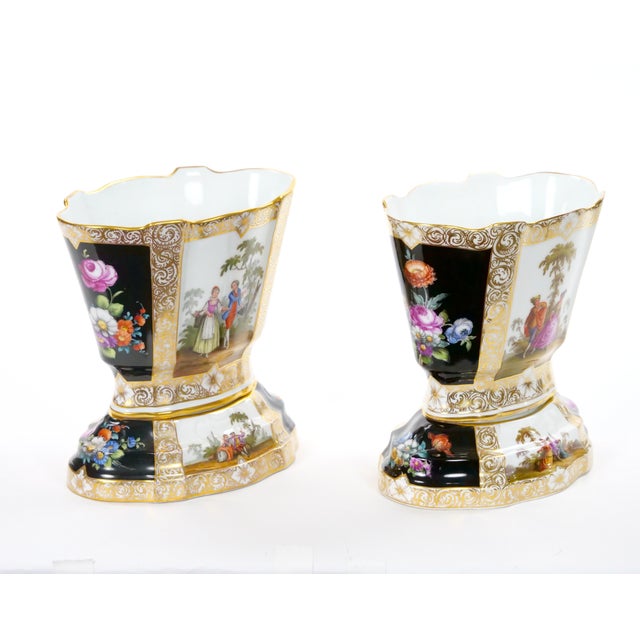 An elegant pair of late 19th century Dresden porcelain decorative cachepots, beautifully crafted in Germany by the...