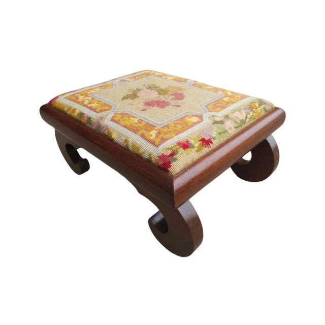 19th Century American Empire Magogany and Needlepoint Upholstered Foot Stool. Measures 21.75" in width, 15.75" in depth...