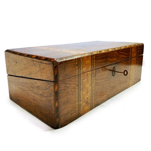 A beautifully crafted mid-19th century English Tunbridge ware writing slope, showcasing intricate micro-mosaic banding in...