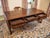 Large writing desk made of solid oak with a writing board covered with leather. The leather writing surface is decorated...