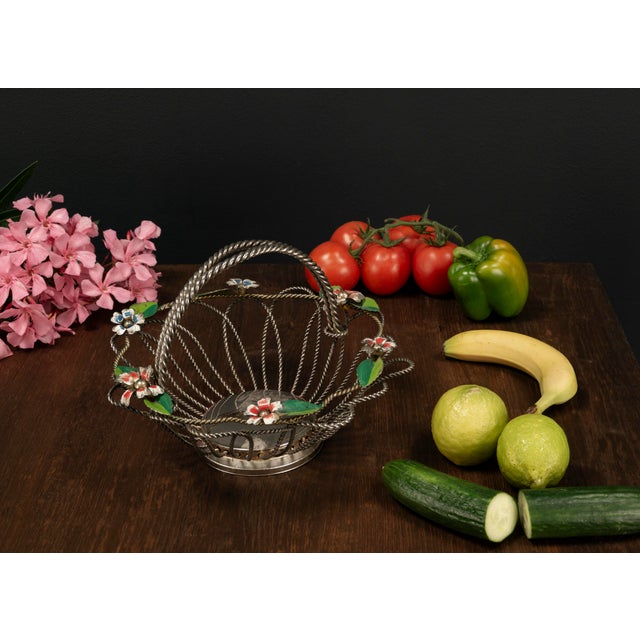 This silver plated Mid Century vintage fruit basket from the 1950s features a delicate yet robust construction made of...