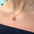 18K yellow gold Star of David pendant set with six trillion cut natural rubies totaling 0.73 carats, on an 18 inch cable...