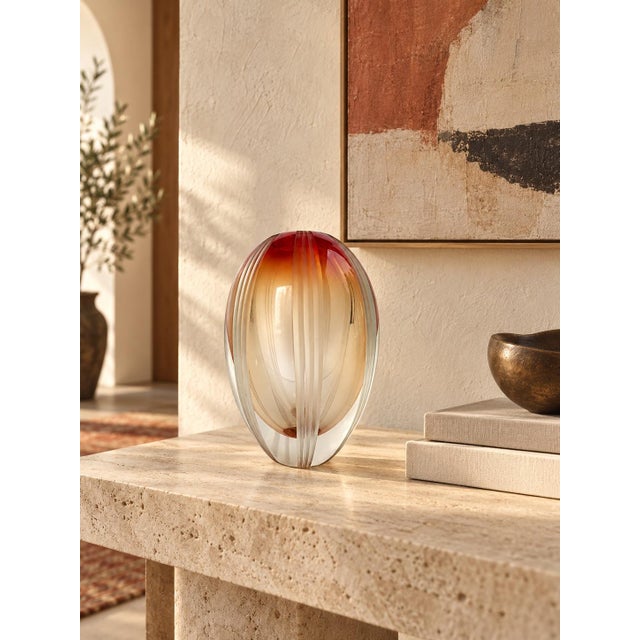A striking “Mesa Sunrise” art glass vase from the Evolution by Waterford collection, crafted in Poland. This sculptural...