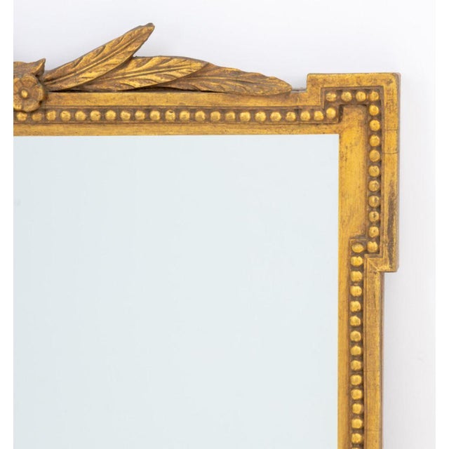 George III Style Giltwood Framed Mirror, with floral crest to the top and gadrooned trim. Mirror: 35.5" H x 23.5" W;...