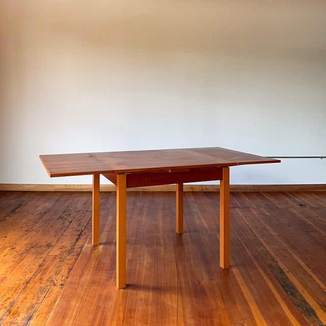Danish Modern teak dining table. Hidden leaves built into the table for an easy pullout extension. This versatile table is...
