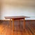 Danish Modern teak dining table. Hidden leaves built into the table for an easy pullout extension. This versatile table is...