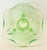 Vintage Fostoria candle holders are crafted from green uranium glass. Three-footed base with a scalloped, bowl-shaped top...