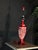 Description A bold decorative table lamp base featuring an ornate openwork form and distressed red finish. The sculptural...