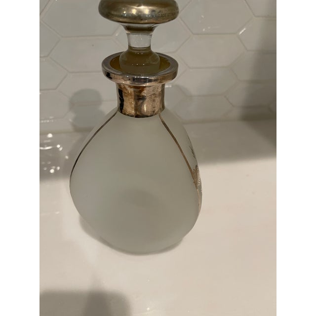 Art Deco pinched glass decanter with sterling silver overlay and stopper. "Scotch" is written on the front in silver...