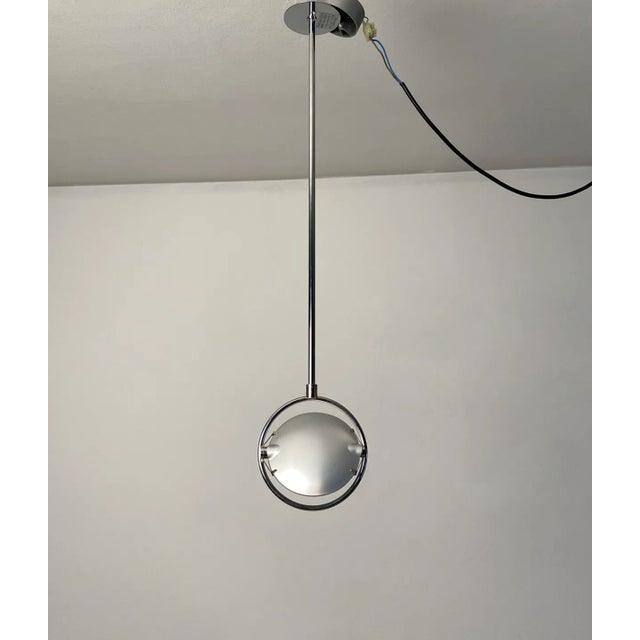 Nobi 3023/1 model by FontanaArte. Fixed length polished steel stem. Two concave glasses placed side by side are held in...